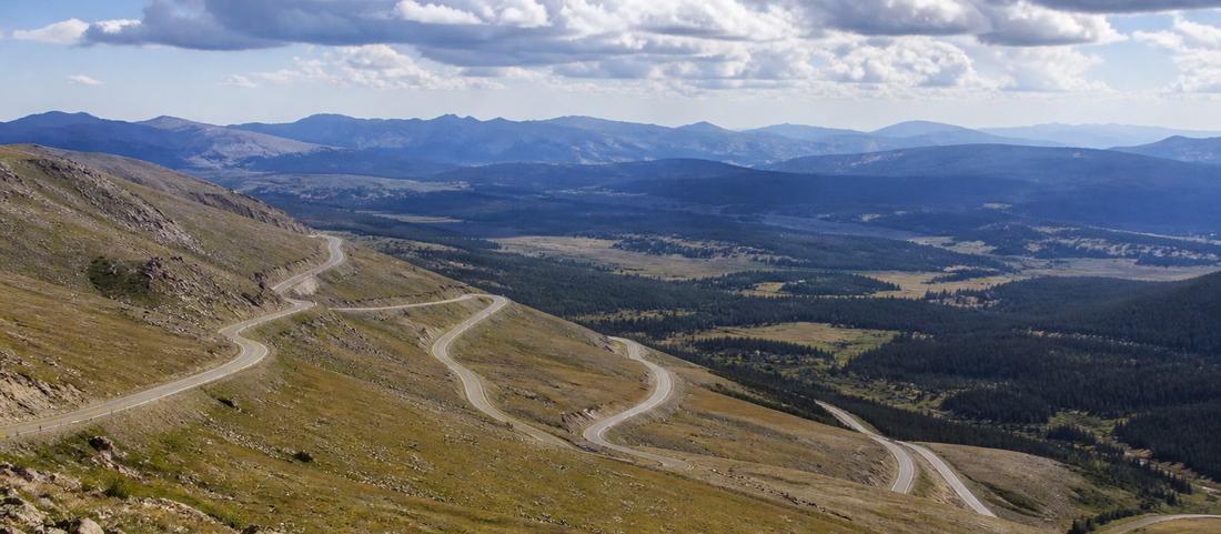 Switchbacks descending from a high pass into a broad Wyoming valley