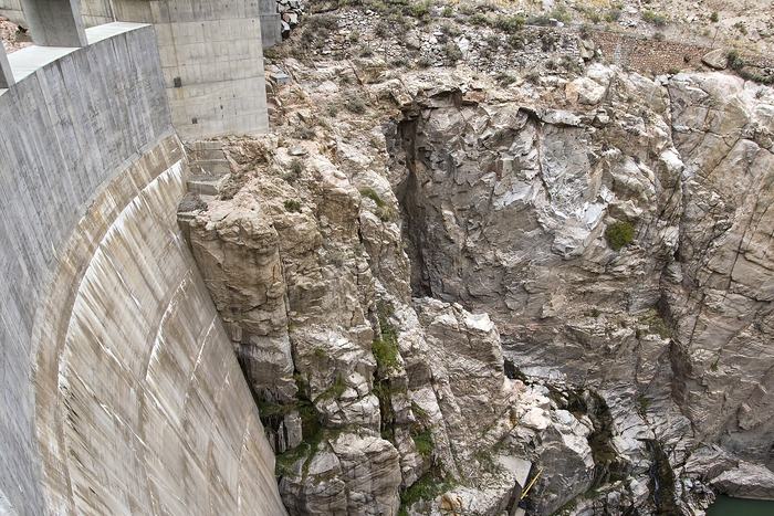 The concrete arch of Buffalo Bill Dam between the canyon walls